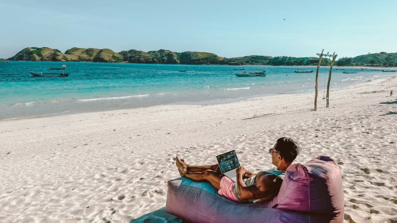 Remote worker on beach with laptop - the new flexibility in careers